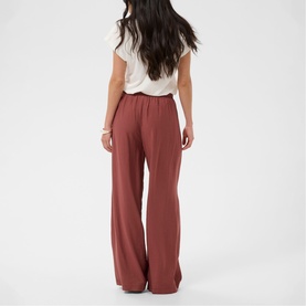 Model wearing Kaffe henna wide-leg trousers, back view, styled with a white T-shirt