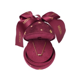 Missoma gold delicate necklace displayed in a burgundy velvet gift box with star embellishments and satin bow