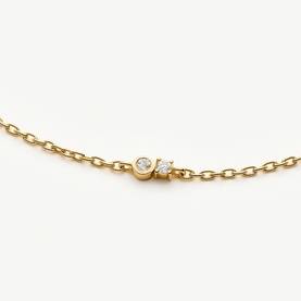 Missoma gold bracelet with bezel-set and pav&eacute; diamond cluster pendant on fine gold chain