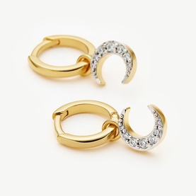 Missoma gold hoop earrings with pav&eacute; crystal crescent moon charm drops, shown as a pair