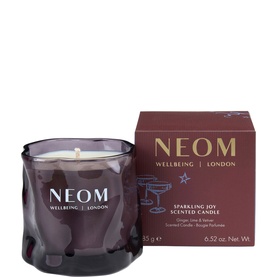 Neom Organics Sparkling Joy Scented Candle in deep plum glass vessel with matching branded gift box
