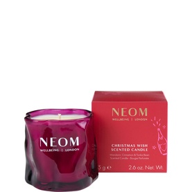 Neom Organics Christmas Wish Scented Candle in faceted deep pink glass vessel with matching red gift box