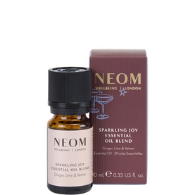 Neom Organics Sparkling Joy Essential Oil Blend, small amber glass bottle with dark cap beside matching product box