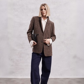 Model wearing The Landskein Lucien Houndstooth Double-Breasted Blazer in Textured Tweed, styled with white shirt and navy wide-leg trousers