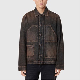 Model wearing All Saints washed brown denim jacket with oversized chest pockets, contrast stitching, and button-front fastening
