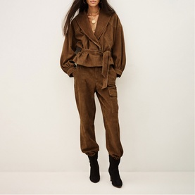 Model wearing Bash Manon Belted Suede Jacket in brown with large cowl collar and detachable belt, styled with matching brown cargo trousers and black