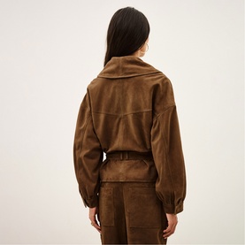 Model wearing Bash Manon Belted Suede Jacket in brown, with large cowl collar, V-back panels and ruffled cuffs, styled with matching brown trousers