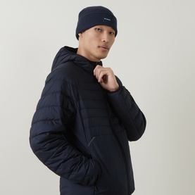 Model with Columbia City Trek&trade; Logo Beanie Hat in Colgate Navy, styled with a matching navy quilted hooded jacket.