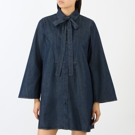 Model wearing FRAME DENIM Rinse denim dress with bow neck tie, wide sleeves, and button-front placket in dark indigo wash