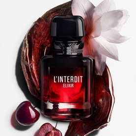 Givenchy L'Interdit Elixir Eau De Parfum in dark red and black bottle, styled with white flower and dark cherries.