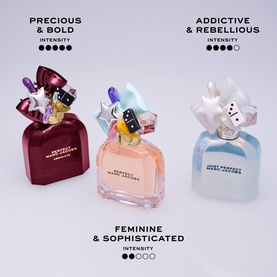 Marc Jacobs Just Perfect Eau de Parfum collection: three bottles in burgundy, peach, and pale blue with charm-topped caps, labelled by intensity