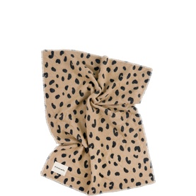 BiniBamba muslin blanket in Leopard print, twisted into a gathered bundle, featuring black spot pattern on sandy beige fabric