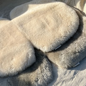 BiniBamba Toast fluffy sheepskin sleep mask and matching slippers laid flat on a soft white surface