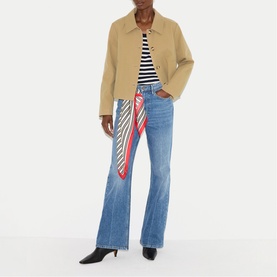 Model wearing Jigsaw beige short jacket with black and white striped top, blue flare jeans and a red printed scarf tied at waist