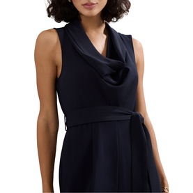 Model wearing Phase Eight blue sleeveless cowl-neck dress with tie waist belt, shown in close-up crop