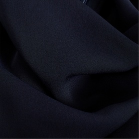 Phase Eight blue dress fabric close-up, showing smooth draped texture in deep navy tone