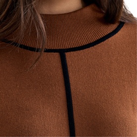Model wearing Phase Eight brown knit dress with mock turtleneck and contrast navy tipping detail
