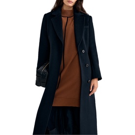 Model wearing Phase Eight brown midi dress styled under navy double-breasted longline coat, carrying black quilted bag