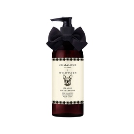 Jo Malone x WildWash Orange & Cedarwood Dog Shampoo in dark amber pump bottle with black bow and houndstooth label