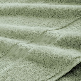 Christys Thyme bath towel in soft green, close-up showing plush terry loop pile texture and woven border detail