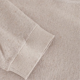 Phase Eight gold knit jumper close-up showing ribbed cuff and sleeve detail in metallic fine-knit fabric