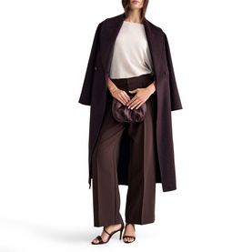 Model wearing Phase Eight long burgundy coat with wide-leg trousers and white top, styled with heeled sandals and a ruched clutch bag