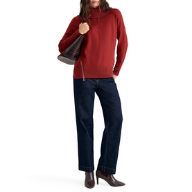 Model wearing Phase Eight orange turtleneck zip-detail jumper with dark navy wide-leg jeans and brown ankle boots, carrying a brown bag