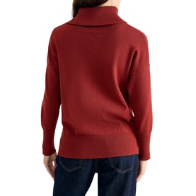 Model wearing Phase Eight orange turtleneck knit jumper, back view, styled with dark blue jeans