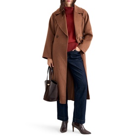 Model wearing Phase Eight orange longline wool coat, styled with red roll-neck, navy wide-leg jeans, brown heeled boots and tote bag