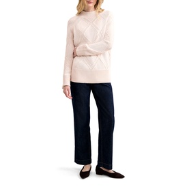 Model wearing Phase Eight pink cable-knit jumper with mock neck, styled with dark wide-leg jeans and black flat shoes