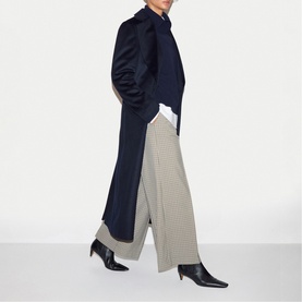 Model wearing Jigsaw navy long coat with houndstooth wide-leg trousers and black pointed heeled ankle boots.