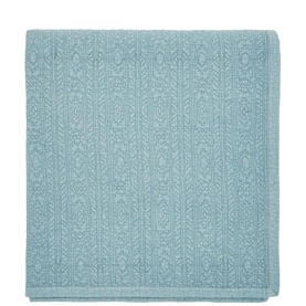 Folded duck egg blue cotton throw with tonal jacquard geometric and leaf pattern detail