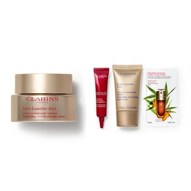 Clarins Nutri-Lumiere Gift Set featuring day cream, eye treatment, and serum, displayed together on white background
