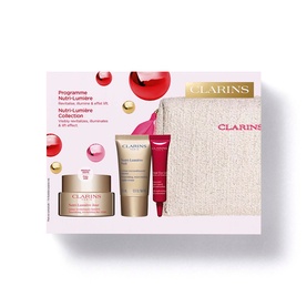 Clarins Nutri-Lumiere Gift Set with day cream, serum, eye cream, and beige branded pouch on white background
