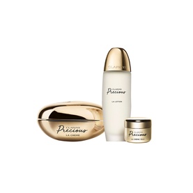 Clarins Precious Exceptional Skincare Gift Set featuring La Cr&egrave;me, La Lotion, and La Cr&egrave;me Yeux in gold packaging