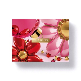 Clarins Multi-Active Gift Set packaging featuring bold red, pink and gold floral design with decorative spheres on pale pink background.