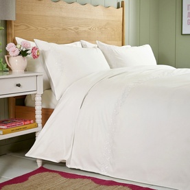 Helena Springfield White Duvet Set styled on a double bed with matching pillowcases, in a bright bedroom setting.