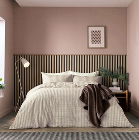 Helena Springfield Chocolate Duvet Set in cream and brown check, styled on a double bed with coordinating pillowcases in a pink bedroom setting.