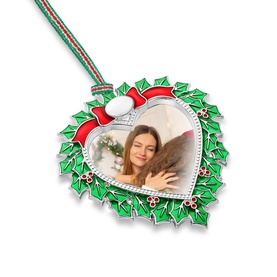 Newbridge silver heart-shaped Christmas photo frame ornament with green holly, red bow, and striped ribbon hanger