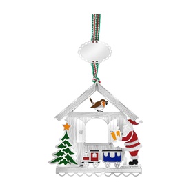 Newbridge silver metal Christmas house ornament with Santa, train, and tree details, hanging from striped ribbon