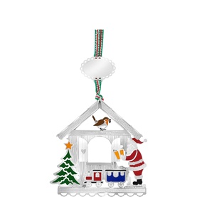 Newbridge silver metal Christmas house ornament with Santa, train, and tree details, hanging from striped ribbon
