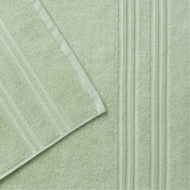 Christys green bath towel with ribbed border detail, shown folded to display soft terry cloth texture
