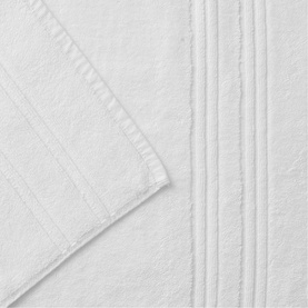 Christys white bath towel with textured stripe border detail, shown folded to display soft terry cloth texture.