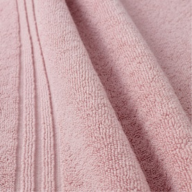 Soft blush pink terry towel with ribbed border detail, shown in close-up to highlight plush texture