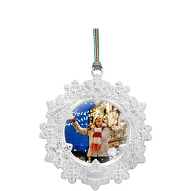 Newbridge silver snowflake Christmas tree ornament with festive scene insert, hung with red and green ribbon