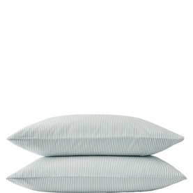 Pair of pillowcases in pale blue and white fine stripe pattern, stacked, showing classic Oxford-style finish