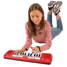 Child lying down playing Bontempi red and black toy keyboard with white keys and colourful buttons