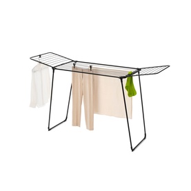 Brabantia Matt Black foldable clothes drying rack with winged arms, displayed with hanging laundry and green accessory hook