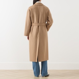 Model wearing Max Mara camel wool coat, back view, with belted waist and longline silhouette, styled with blue jeans