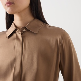 Model wearing Max Mara Studio tobacco silk shirt, close-up of pointed collar with gold-tone pin detail